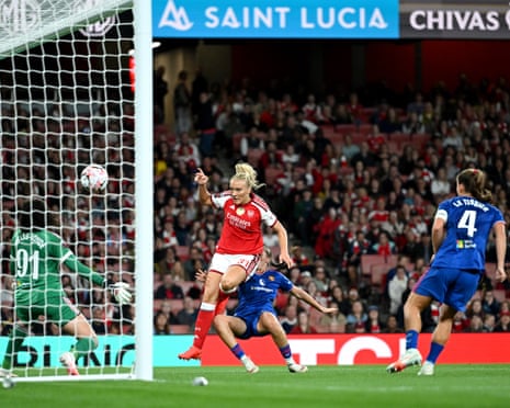Smilla Holmberg of Arsenal shoots toward the goal past a diving defender