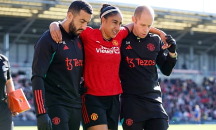 Manchester United’s Gabby George (centre) leaves the pitch after an injury during the Women’s Super League match against Leicester at the Leigh Sports Village