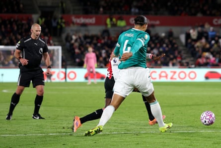 Virgil van Dijk makes contact with Dango Ouattara on the edge of the penalty area.