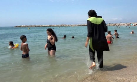 Nissrine Samali, 20, gets into the sea in Marseille wearing a burkini