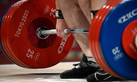 A weightlifter steadies himself during the Tokyo 2020 Olympic Games. More than 600 lifters have tested positive for doping in the past decade.