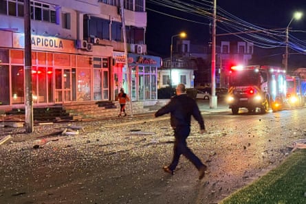 Person walking on debris-strewn road