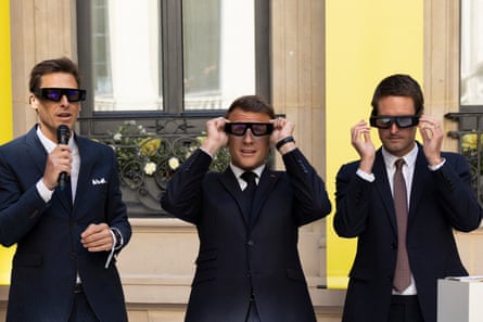 Three men in suits put on dark oversized glasses.