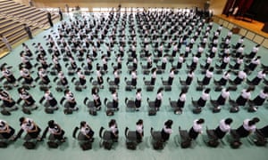 High school students wearing masks participate in a school reopening ceremony on June 1, 2020.