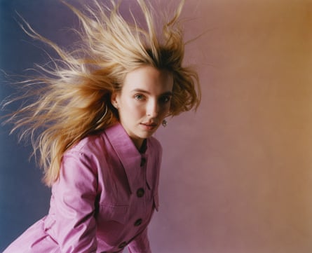 Jodie Comer in pink coat against purple and yellow background, Sept 2021