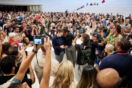 Excitement builds at the crowded launch in California of the new iPhones.