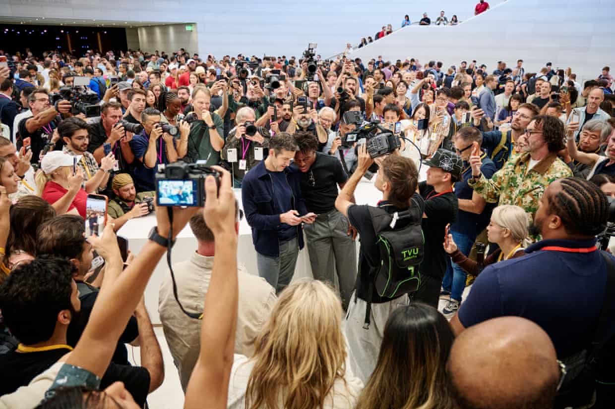 Excitement builds at the crowded launch in California of the new iPhones.