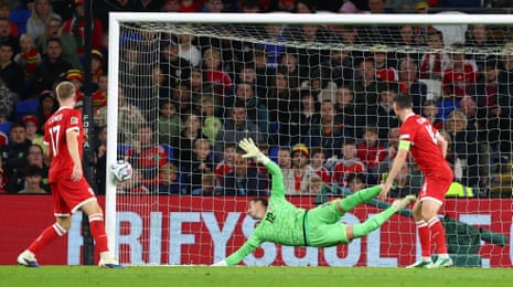 Danny Ward of Wales makes a diving save onto the post from Gustav Isaksen of Denmark.