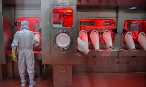 An employee in protective gear works on an assembly line for manufacturing vials of Covishield, Oxford/AstraZeneca’s Covid-19 coronavirus vaccine at India’s Serum Institute in Pune.