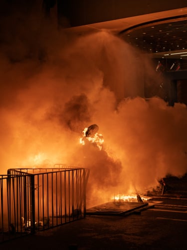 Barricade, Hong Kong, 2019 smoke and flames rise around railings