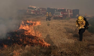 A Santa Clara Cal Fire crew scrambles to extinguish a spot fire