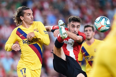 Antoine Griezmann of FC Barcelona competes for the ball with Unai Lopez of Athletic Club.