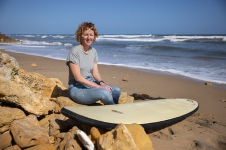 Day at the Beach. Gill Hutchison on the beach in Torquay, south-west of Melbourne, holding a “foamie” the soft type of surfboard that she caught her first wave on. Australia.