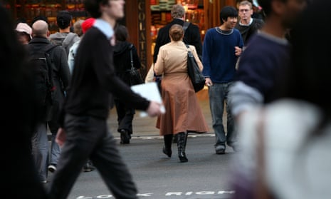 Pedestrians cross an intersection in Sydney’s central business district.