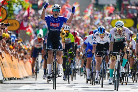 Belgian rider Jasper Philipsen celebrates as he beats the pack to win the stage.
