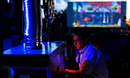 D Edward Vogel, owner of Bengies, prepares a film on his projector. US.