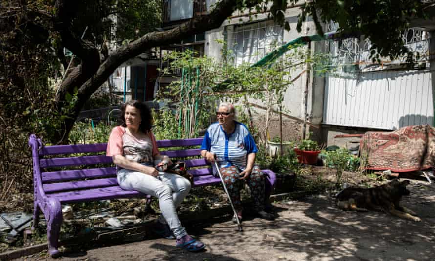 Elena Voitenko (left) and Alla Petrivna in front of their damaged building.