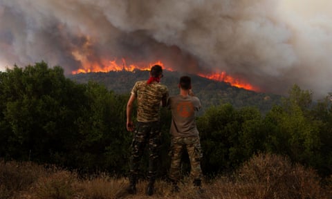 Flames burn a forest  near Sykorrahi in the north-eastern Evros region