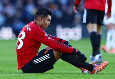 Casemiro sits on the turf