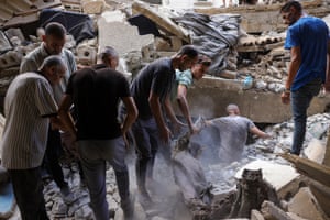 Palestinians look for survivors in the rubble of a building