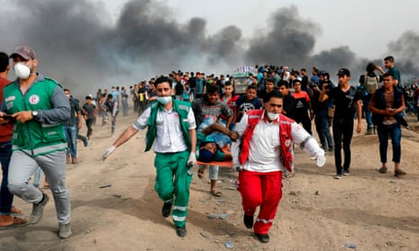 Palestinian medics evacuate a wounded protester during clashes with Israeli forces east of Gaza City.