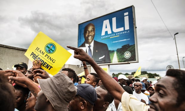 Supporters of Jean Ping rally in Libreville in front of a poster of President Ali Bongo Ondimba.