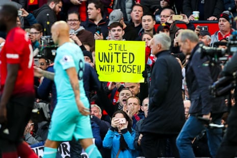 A fan holds up a sign supporting Jose Mourinho.