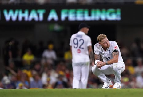 England’s Ben Stokes looks dejected as an advertising sign in the background reads ‘What A Feeling!’ on day two of the second Ashes Test at The Gabba.