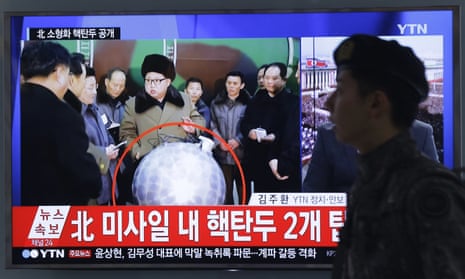 A South Korean army soldier walks by a TV screen showing North Korean leader Kim Jong Un with superimposed letters that read: ‘North Korea’s nuclear warhead’.
