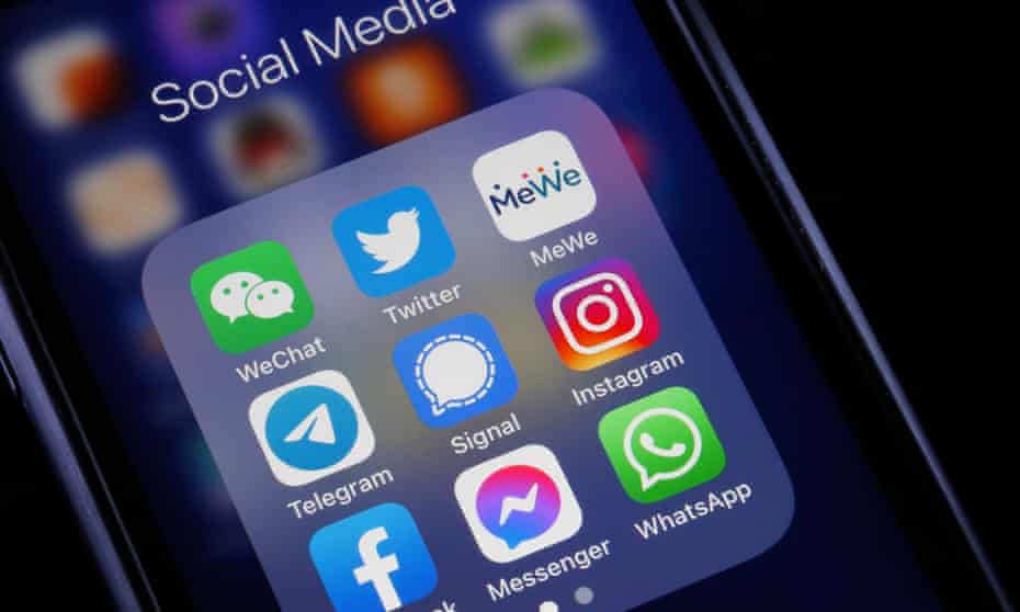 Logos of social media applications, WeChat, Twitter, MeWe, Telegram, Signal, Instagram, Facebook, Messenger and WhatsApp is displayed on the screen of an iPhone 