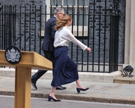 Keir Starmer leaves the No 10 podium with his wife, Victoria, after announcing his resignation, 22 June 2026.
