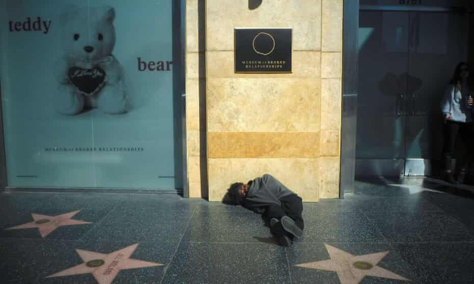A man sleeps on the Walk of Fame sidewalk in Hollywood, California. The county of Los Angeles has promised to house 45,000 homeless people over the next five years. 