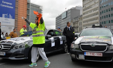 Taxi drivers with wanted posters on the sides of their cars in Brussels in September 2015 during a protest against Uber