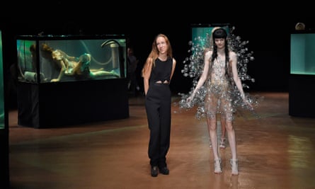 Fashion designer Iris van Herpen (left) stands beside a model in Paris in 2017.