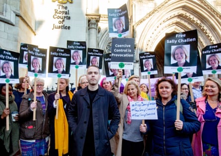 Dozens of people with placards which read ‘Free Sally Challen’ above a photograph of her, stand behind a young man.