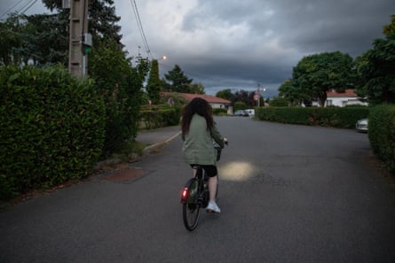 Nihal rides her bike as it gets dark
