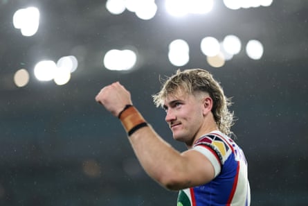 Fletcher Sharpe pumps his fist in celebration after the preliminary final with the stadium lights in the background
