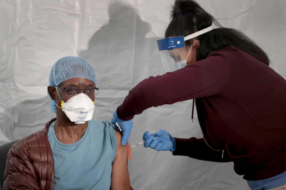 Dr Tunji Ladipo gets a vaccine at Roseland Community Hospital in Chicago’s far South Side.