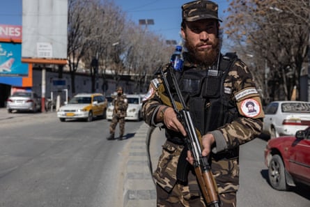 A Taliban soldier stands on a Kabul street