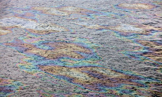 Water glistens with color as light reflects off an oil sheen after a similar spill.