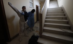 Doctor Elisa Riccitelli, right, and nurse Nurse Luigi Lauri wear protective gear before entering in the home of an elderly Rome resident.