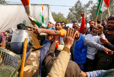 Police try to stop local residents during a clash with farmers at the Singhu camp on 29 January.