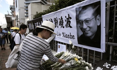 People lay floral tributes to Liu Xiaobo outside the Chinese liaison office in Hong Kong.
