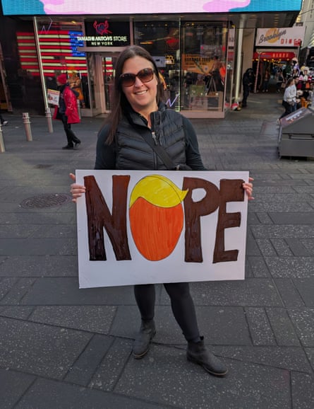 In New York’s Times Square on Saturday, Christina Perez had a message for Donald Trump in a sign she brought to protest his attack on Iran.