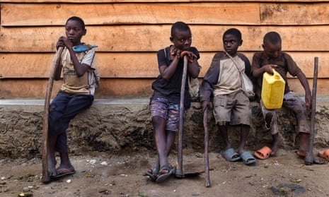 Children rest after a day of work in Kiwanja, eastern Democratic Republic of the Congo