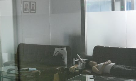 A man sleeps in the closed Air Koryo office in Beijing