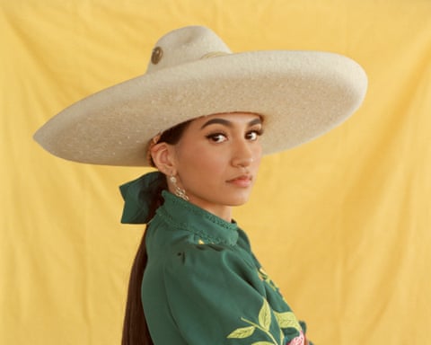 woman poses against a yellow background