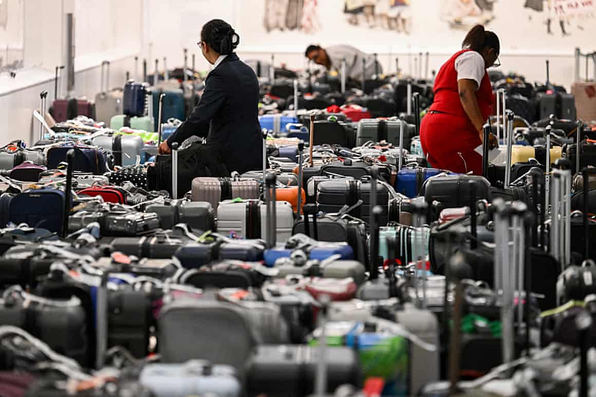 Delta employees look through bags awaiting reunification with their owners in the Delta Air Lines baggage claim area Los Angeles International Airport.