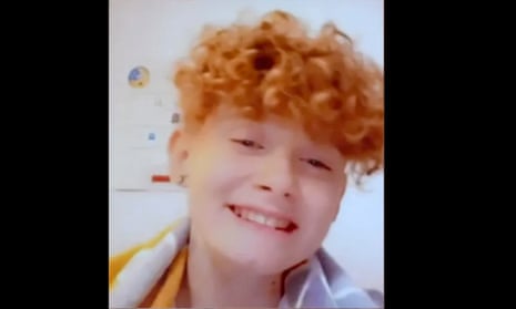 Charlie Millers, with curly red hair, smiling to the camera