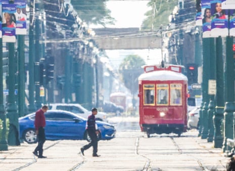 Heatwaves distort streetcars, pedestrians and cars on Canal Street in New Orleans on 28 June.